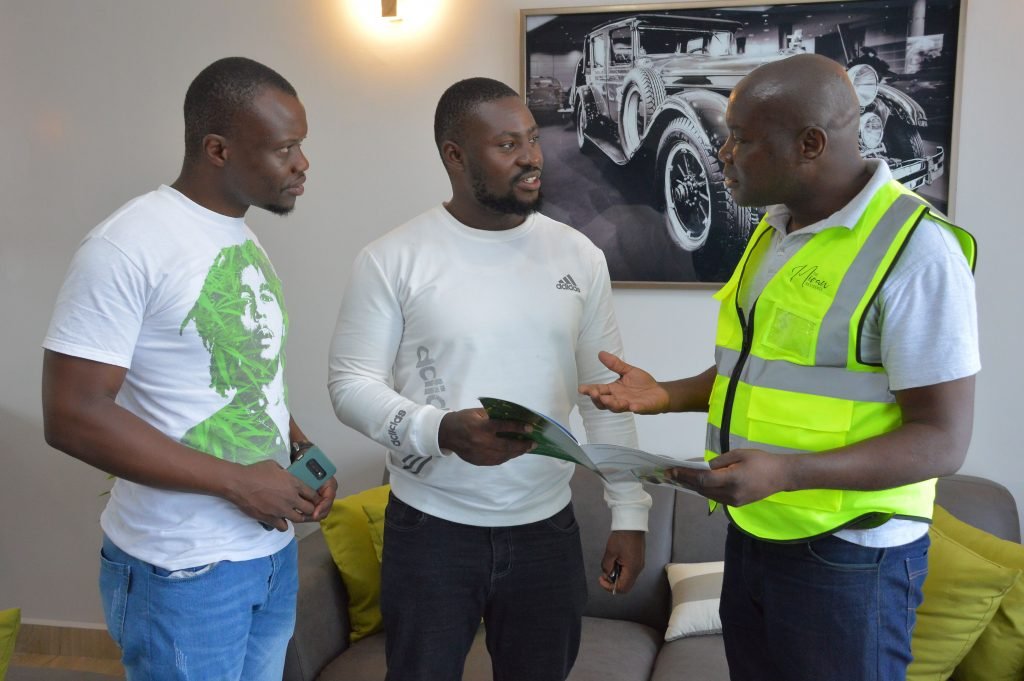 Investors, Dennis Kasuku and Erick Otieno confer with Safaricom Investment Co-operative sales executive Meshack Odongo during the open day for The Miran Residence.