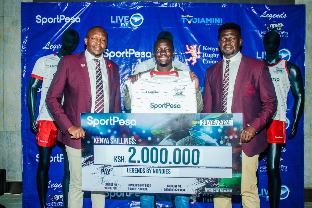 Willis Ojwang (Centre), the public relations manager at SportPesa joined by Auka Gecheo (left), the Nondies Chairman and Eddie Omondi, the team Captain during the partnership unveiling.