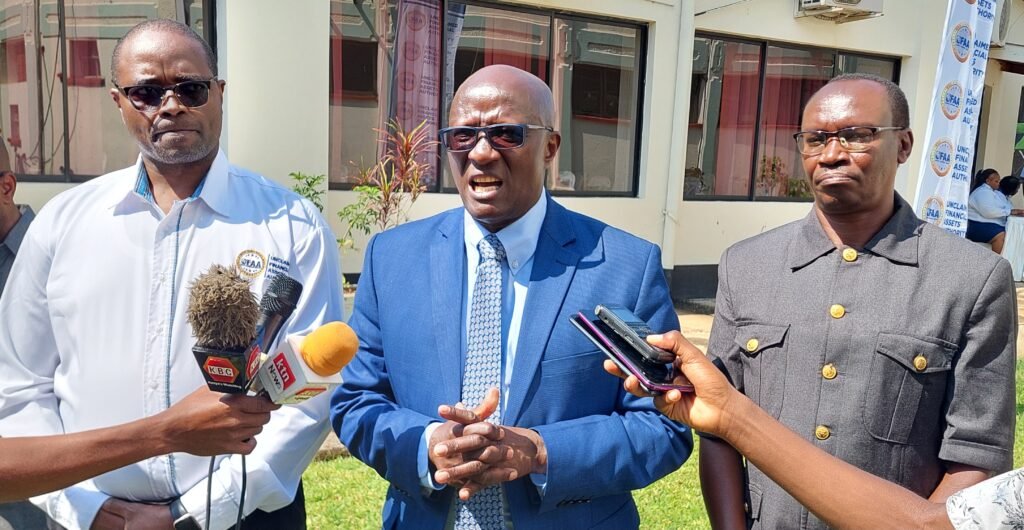 Unclaimed Financial Assets Authority Board Chairman Dr. Francis Njenga (center) addressing the media in Kisumu. Looking on is UFAA Chief Executive Officer John Mwangi left and Kisumu Central Deputy County Commissioner Bosek Lang'at (right). (Photo: Chris Mahandara)